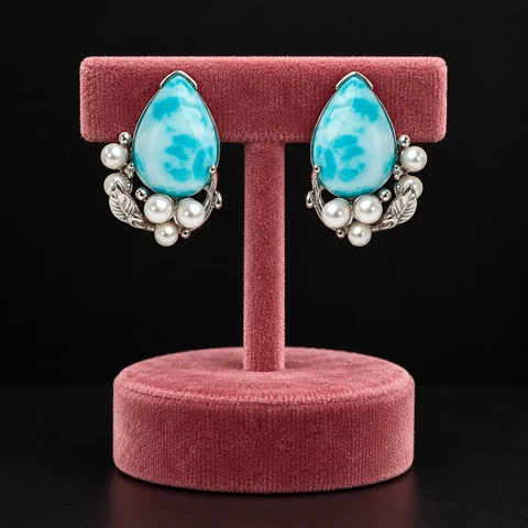 The Cécile Jardin Blue Earrings on a jewelry display — AI-generated styling preview
