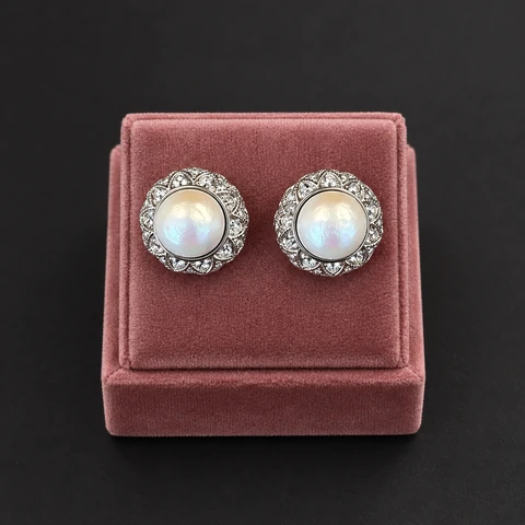 The Louise Fleur White Earrings on a jewelry display — AI-generated styling preview